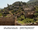 Ruins of houses on a hill in the abandoned village of Kayaköy, Livissi, close to Fethiye, Turkey 2022