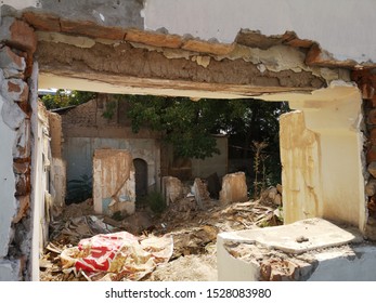 The Ruins Of An Old Poor Little House. The House Of Clay And Brick Is Destroyed. A Rural House Is Falling Apart From Old Age.