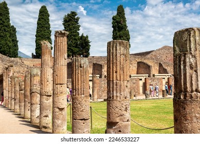 Ruins of Pompeii near Naples, Italy. Pompeii is Ancient Roman city, World landmark. Scenery of Gladiators Barracks columns or Quadriporticus. Theme of travel, sightseeing and tourism in Pompeii.