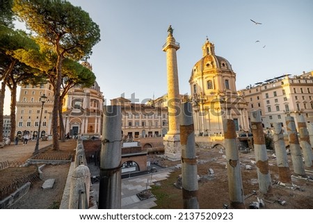 Ruins of Roman forum with Trajan column and church of the Most Holy Name of Mary. Rome cityscape at sunset. Concept of historical landmarks and travel Italy