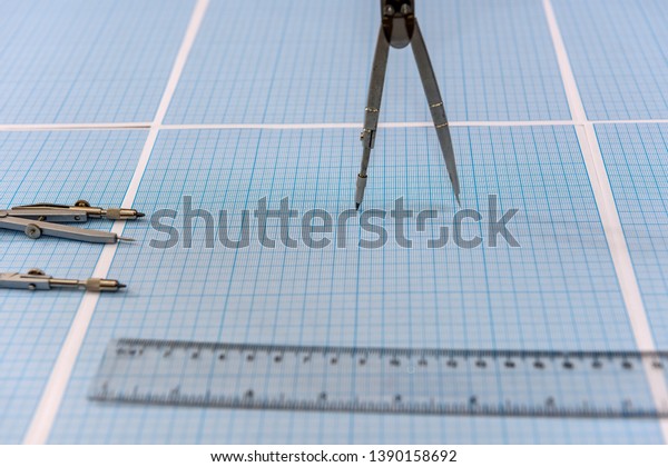 Ruler with\
compass on millimeter paper at\
desk