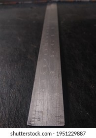 A Ruler On A Black Plinth