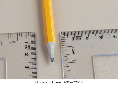 Ruler and yellow pencil. Measurement tool. Inch and metric system.