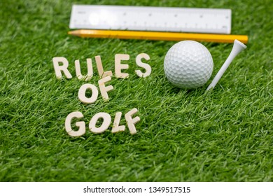 Rules Of Golf With Golf Ball And Pencil On Green Grass