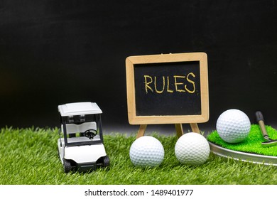 Rules Of Golf With Golf Cart And Golf Balls Are On Green Grass