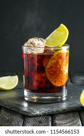 Rum And Cola Cocktail On Dark Background