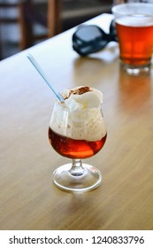 The Rum And Honey Mixture (called Ron Miel) Served With Whipped Cream And Cinnamon In A Glass. Lanzarote Special Traditional Drink, Canary Island, Spain 