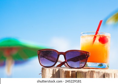 Rum Punch Cocktail And Sunglasses At Tropical Beach.