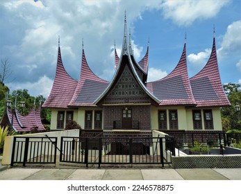 Rumah Gadang is a traditional house in West Sumatra, Indonesia. has the characteristic of the end of the roof which is higher than the middle roof, and this house is made of wood. - Shutterstock ID 2246578875