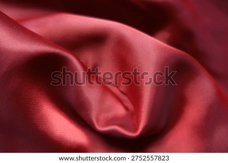 Rumpled smooth red satin polyester lining fabric