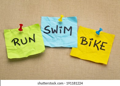 run, bike, swim - triathlon or fitness concept - words on sticky notes
