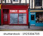 Run down closed shop boarded up local business retail store in economic bankrupt recession hit old market town out of business with no customers and deserted streets under railway arches in Mansfield