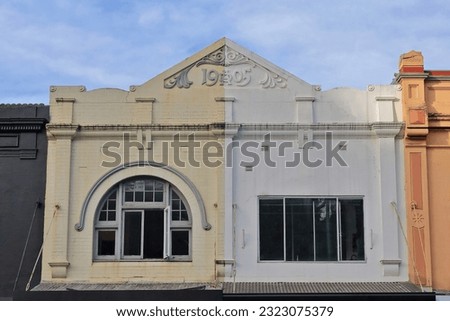 Run of manycolored Victorian commercial terraces dating fron AD 1905 with ornate parapet and cantilevered awnings over the footpath frontshops of Oxford Street-Paddington suburb. Sydney-NSW-Australia.