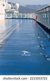 The RUN Word On The Blurry Metal Floor Of The Blurry Cruise Ship, On A Sport Deck On A Sunny Day