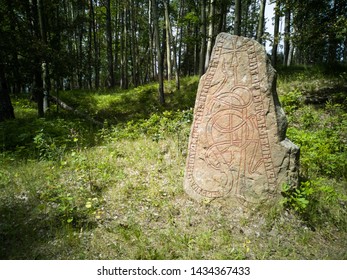 Rune Stone. Ancient Big Stone with runes patterns. Vikings Times. An old grave in the Scandinavian forest. Traditional tomb of ancient people who lived in Scandinavia. 