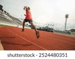 The runer runs on a red rubber running track, starting off using the starting block. Sports.Sprinter Leave the default block to track work. Young couple running on the road running for fitness.