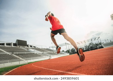 The runer runs on a red rubber running track, starting off using the starting block. Sports.Sprinter Leave the default block to track work. Young couple running on the road running for exercise. - Powered by Shutterstock