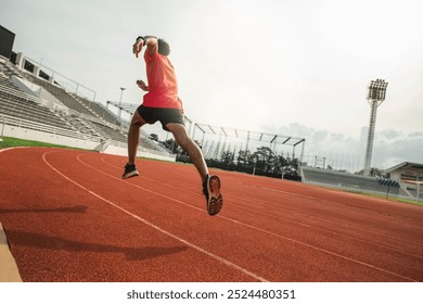 The runer runs on a red rubber running track, starting off using the starting block. Sports.Sprinter Leave the default block to track work. Young couple running on the road running for fitness. - Powered by Shutterstock