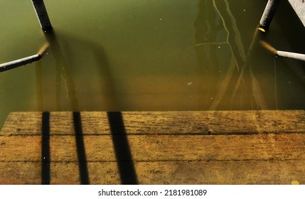 Rung Of Wooden Ladder Under Water