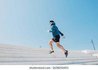 Runner Ascends Bright White Steps Under a Clear Blue Sky in an Energetic Display of Fitness and Determination During a Sunny Day