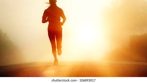 Runner athlete feet running on road. woman fitness silhouette sunrise jog workout wellness concept. - Powered by Shutterstock