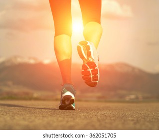 Runner athlete feet running on road under sunlight. - Shutterstock ID 362051705