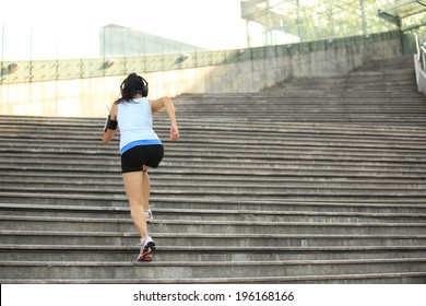 Runner athlete running on stairs. woman fitness jogging workout wellness concept. 