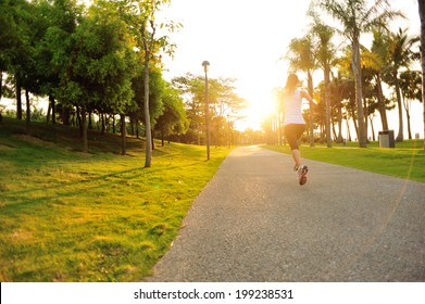 Runner Athlete Running On Tropical Park Trail. Woman Fitness Jogging Workout Wellness Concept.