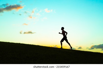 Runner athlete running outdoors. Fitness jogging workout wellness concept.