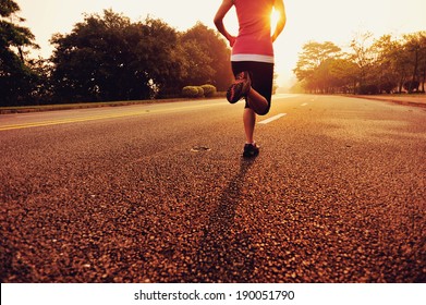 Runner athlete running at road. woman fitness sunrise jogging workout wellness concept.  - Shutterstock ID 190051790