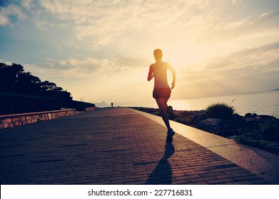Runner athlete running at seaside. woman fitness silhouette sunrise jogging workout wellness concept.  - Shutterstock ID 227716831