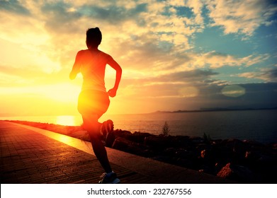 Runner athlete running at seaside. woman fitness silhouette sunrise jogging workout wellness concept.  - Powered by Shutterstock