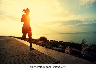 Runner athlete running at seaside. woman fitness silhouette sunrise jogging workout wellness concept.  - Powered by Shutterstock