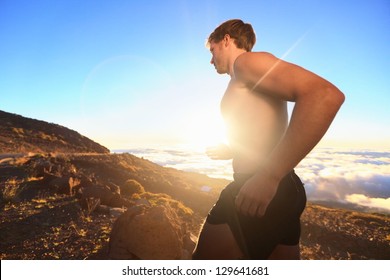 Runner Athlete Running. Sport Man Jogging Outdoor In Sunshine At Sunset In Scenic Nature. Fit Muscular Male Fitness Guy Training Trail Running For Marathon Run. Sporty Fit Athletic Man Working Out.