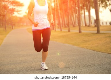 Runner athlete running at tropical park.woman fitness jogging workout wellness concept. 