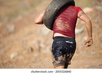 Runner carrying tire in a test of the race