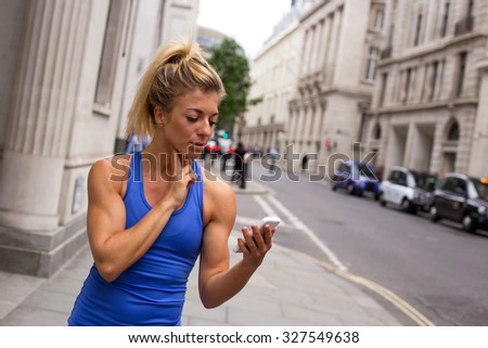 runner checking her pulse in the street