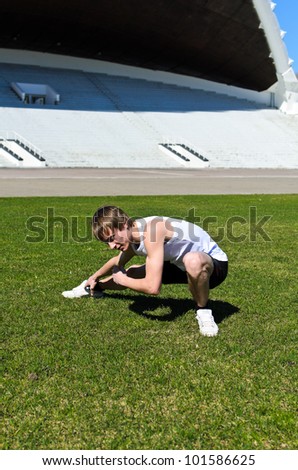 Similar – Athlete at the city park warming and stretching