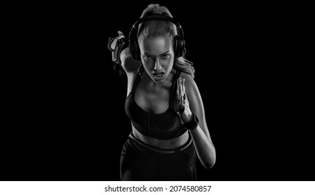 Runner Concept. Sprinter Run. Strong Athletic Woman Running On Black Background Wearing In The Sportswear. Fitness And Sport Motivation.