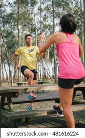 Runner Couple Doing Toe Taps Hiit Exercise For Warming Up Before Running.  Trainer Showing Fitness Workout At The Same Time.