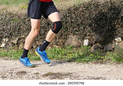 Runner During The Cross-country Race With His Knee Wrapped By A Knee Brace