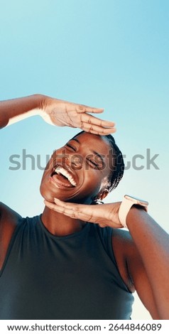 Runner, hands frame and portrait with black woman in city for fitness, photography and wellness. Happiness, workout and marathon with low angle of person on blue sky for space, picture and smile
