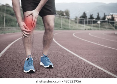 Runner With Injured Knee On The Track