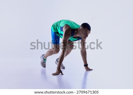 Runner leaning forward in sprint launch motion. Concept of sports ads, athlete motion studies, professional training materials, and dynamic visuals for fitness products.