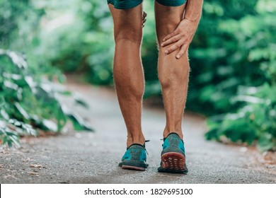 Runner leg injury painful leg. Man massaging sore calf muscles during running training outdoor from pain.