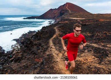 Runner man sport athlete ultra running on endurance trail race competition training on volcano cliff wearing compression clothes, sunglasses smartwatch wearable device. - Shutterstock ID 2138105061