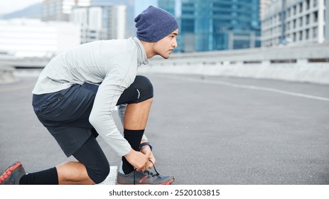 Runner, man or tie shoes in city for morning jog, fitness or getting ready for cardio workout in street. Athlete, person or prepare running sneakers on urban bridge for exercise, training or marathon - Powered by Shutterstock