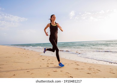 Runner on the beach at dawn.  - Powered by Shutterstock