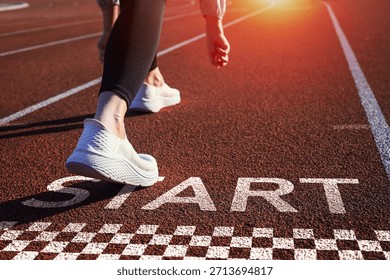 Runner is preparing to take step forward on track with word START. conveys the inspirational concept of starting a business and career path.