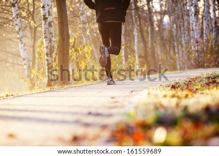 Runner run in park during autumn